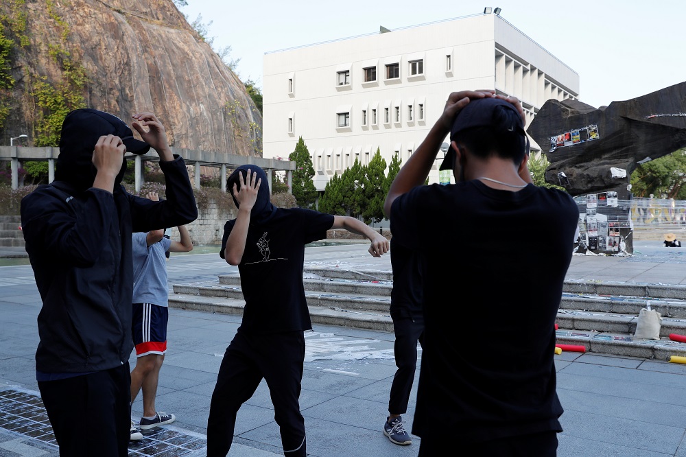 Masked participants shield themselves during a self-defence class organised by a student union at the Chinese University of Hong Kong October 15, 2019. — Reuters pic