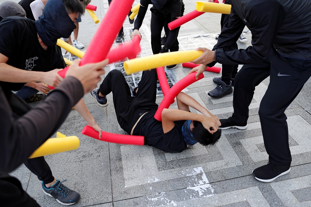 A participant is hit by others using foam sticks during a self-defence class organised by a student union at the Chinese University of Hong Kong October 15, 2019. — Reuters pic