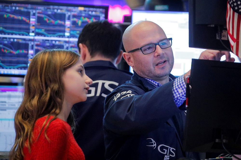 Specialist trader Mario Picone works with his daughter during a traditional bring-your-kids-to-work day on the floor at the New York Stock Exchange November 29, 2019. u00e2u20acu201d Reuters pic