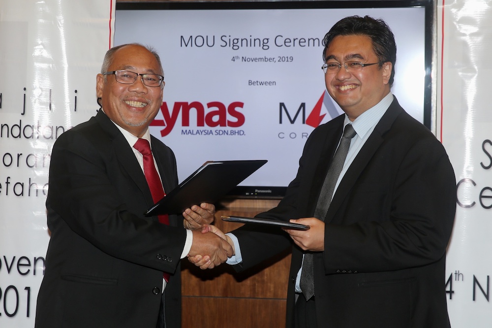 Akhramsyah Muammar Ubaidah Sanusi shakes hands with Datuk Mashal Ahmad after signing an MoU between MARA Corporation and Lynas Malaysia in Kuala Lumpur November 4, 2019. u00e2u20acu201d Picture by Choo Choy May