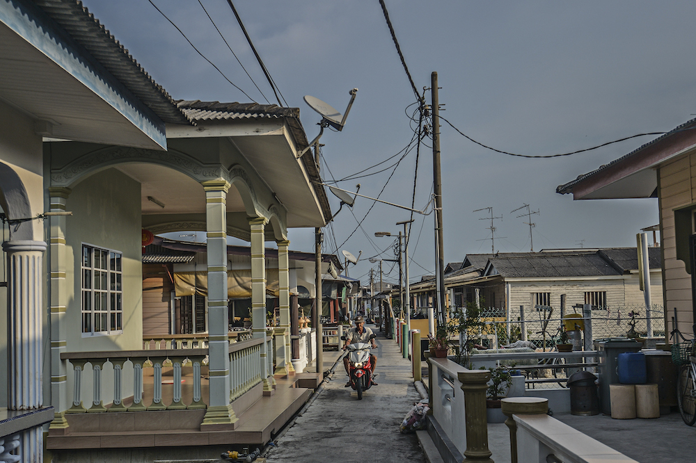 A motorcyclist is seen in Kampung Kukup Laut in Kukup, Pontian November 3, 2019. — Picture by Shafwan Zaidon