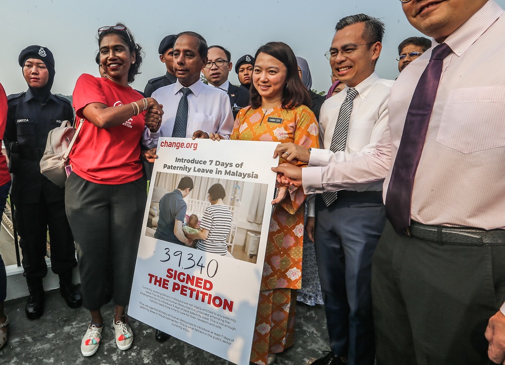 WAO executive director Sumitra Visvanathan hands over a petition to press for paternity leave in the private sector to be extended from three days to seven outside the Parliament in Kuala Lumpur November 13, 2019. u00e2u20acu201d Picture by Firdaus Latif