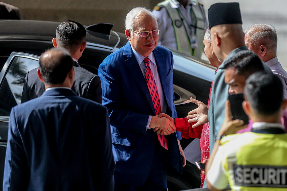 Datuk Seri Najib Razak is greeted by supporters as he arrives at the Kuala Lumpur Courts Complex November 19, 2019. u00e2u20acu201d Picture by Firdaus Latif