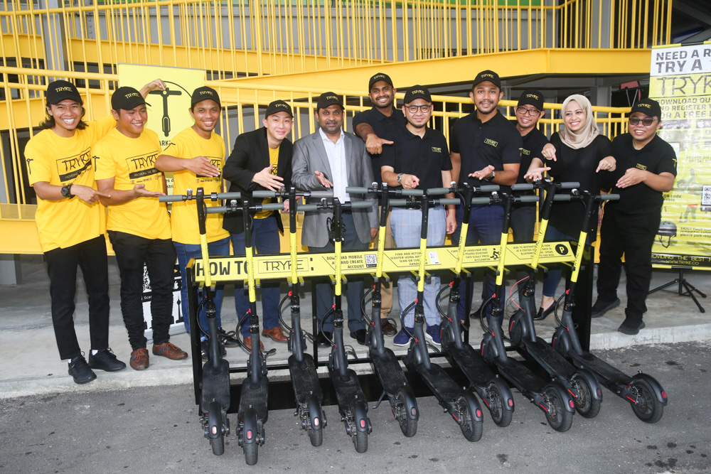 Tryke co-founders Timothy Wong and Shazwan Abdul Razak along with their staff pose for a group picture during the TRYKE e-scooter soft launch at RekaScape in  Cyberjaya November 22 2019 . u00e2u20acu201d Picture by Choo Choy May