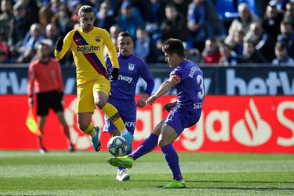 Leganes' Spanish defender Unai Bustinza (right) challenges Barcelona's Antoine Griezmann during the Spanish league football match Club Deportivo Leganes SAD against FC Barcelona at the Estadio Municipal Butarque in Leganes November 23, 2019. u00e2u20acu201d AFP pic