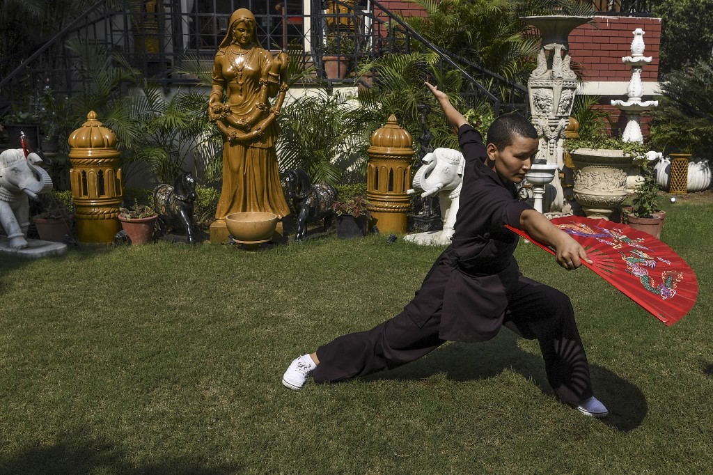 In this photo taken on November 5, 2019, a member of the Kung Fu Nuns group demonstrates her skills in New Delhi.u00e2u20acu201d AFP picnn