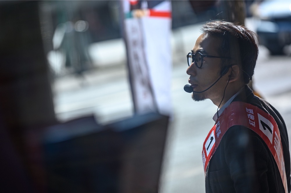 In this picture taken on November 21, 2019, district council election candidate Kwan Siu Lun speaks at his street booth in the Hung Hom district in Hong Kong. u00e2u20acu201d AFP pic