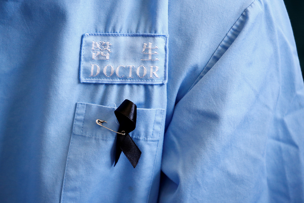 A doctor wears a protest ribbon during a picket by medical staff denouncing what they say is police brutality during recent anti-government protests, at Queen Elizabeth Hospital in Hong Kong August 13, 2019. u00e2u20acu201d Reuters pic