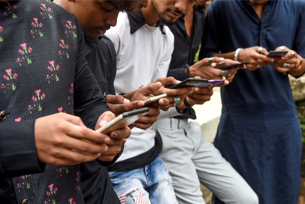 Youngsters watch videos on video-sharing app TikTok on their mobile phones in Mumbai November 10, 2019. u00e2u20acu201d AFP pic 