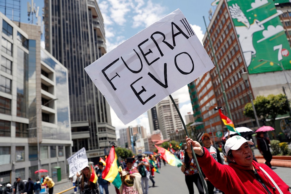 A woman holds a sign reading u00e2u20acu02dcEvo outu00e2u20acu2122 during a protest against Boliviau00e2u20acu2122s President Evo Morales in La Paz, Bolivia November 10, 2019. u00e2u20acu201d Reuters pic   