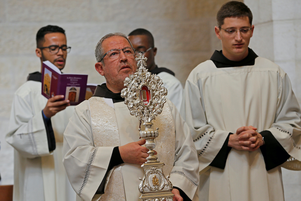 A worshipper holds a wooden relic reputed to be part of Jesusu00e2u20acu2122s manger, upon arrival at the Church of the Nativity in Bethlehem in the Israeli-occupied West Bank November 30, 2019. u00e2u20acu201d Reuters picnnn
