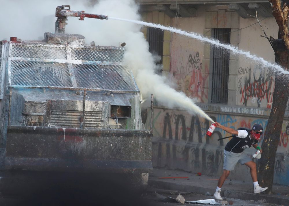 A demonstrator uses a fire extinguisher as he tries to stop a water canon truck during a protest against Chileu00e2u20acu2122s government in Santiago, Chile, November 16 , 2019. u00e2u20acu201d Reuters pic