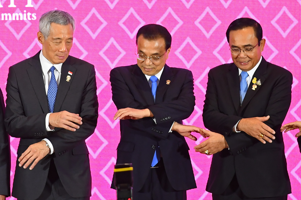 Chinau00e2u20acu2122s Premier Li Keqiang (centre) prepares to pose for a group photo with Singaporeu00e2u20acu2122s Prime Minister Lee Hsien Loong and Thailandu00e2u20acu2122s Prime Minister Prayut Chan-O-Cha during the 22nd Asean-China Summit in Bangkok November 3, 2019. u00e2u20acu201d AFP pic 