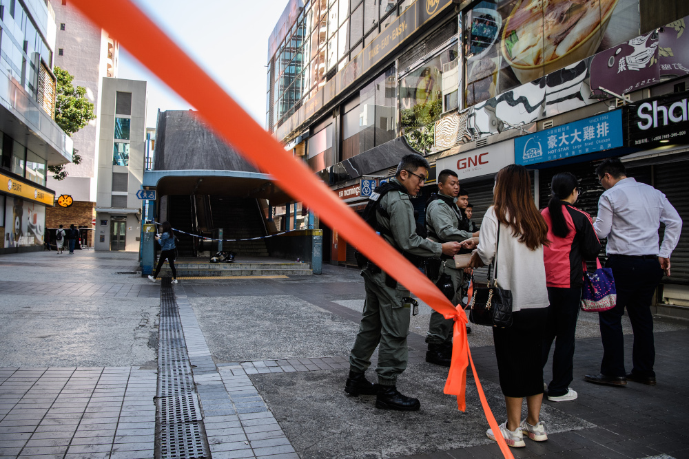 Police check the identity cards of people wishing to enter a cordoned area near the campus of the Hong Kong Polytechnic University in the Hung Hom district of Hong Kong November 21, 2019, where anti-government protesters remained barricaded in. u00e2u20acu201d AFP pi