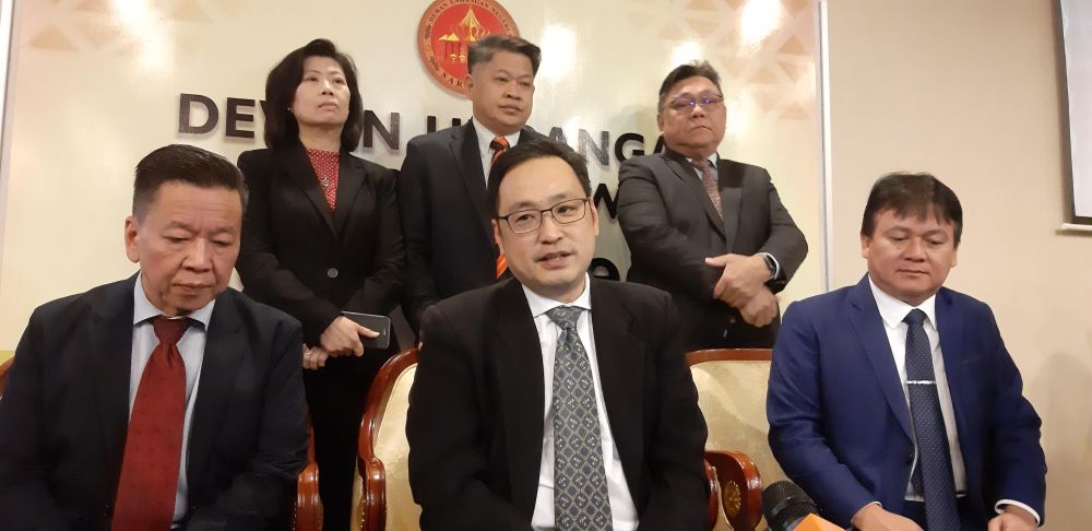 Kota Sentosa assemblyman Chong Chieng Jen (centre) speaks to reporters after his speech was cut short by Speaker Datuk Amar Asfia Awang Nasar earlier. u00e2u20acu201d Picture by Sulok Tawie