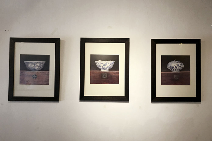 Paintings of old china teacups adorn the wall.