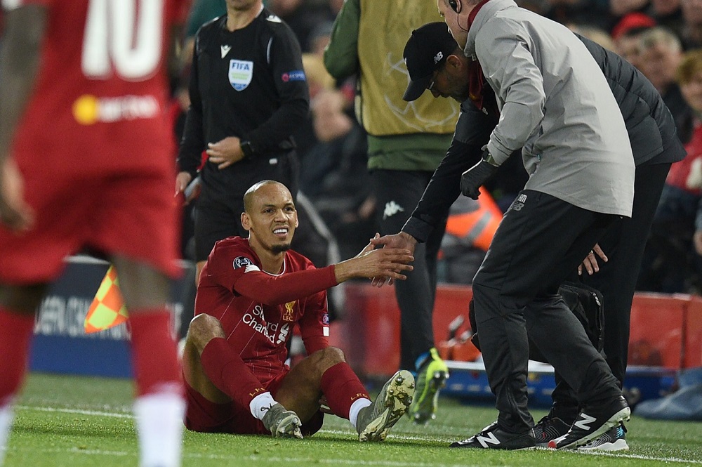 Liverpool's Brazilian midfielder Fabinho (centre) is greeted by Liverpool's German manager Jurgen Klopp as he prepares to leave the pitch injured during the match against Napoli at Anfield in Liverpool November 27, 2019. u00e2u20acu201d AFP pic