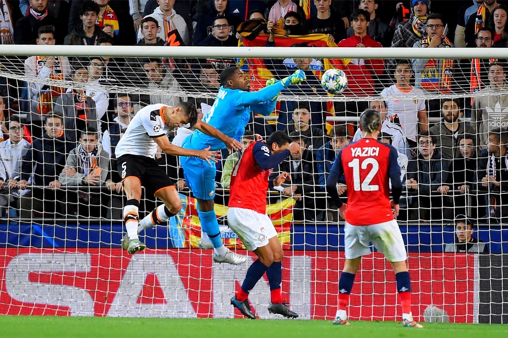 Lille's French goalkeeper Mike Maignan (centre) clears the ball during the match against Lille LOSC at the Mestalla stadium in Valencia November 5, 2019. u00e2u20acu201d AFP pic