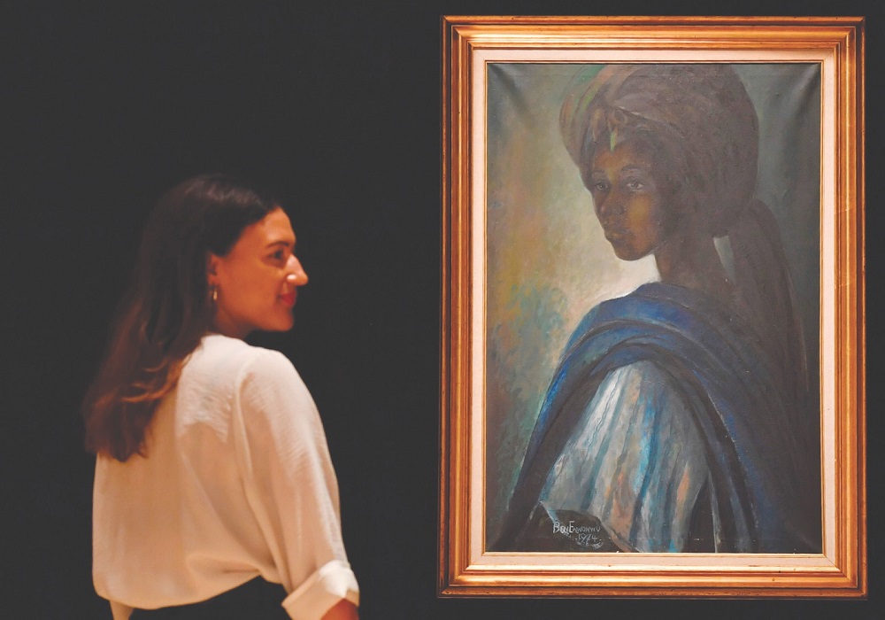 An employee poses with a work of art by Nigerian painter and sculptor Ben Enwonwu entitled u00e2u20acu02dcTutuu00e2u20acu2122, at Bonhams auction house in central London February 7, 2018. u00e2u20acu201d AFP pic