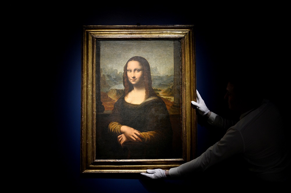 A worker installs a 17th century copy of the painting Mona Lisa before its auction at Sothebyu00e2u20acu2122s auction house in Paris November 14, 2019. u00e2u20acu201d Reuters pic