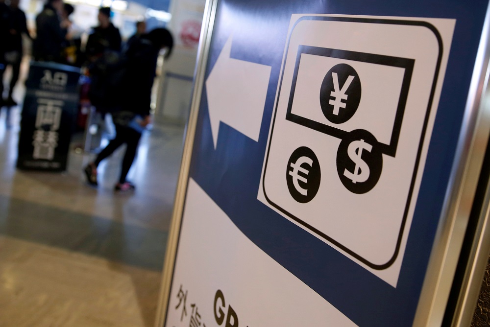 Currency signs for the Japanese yen, the euro and US dollar on a board outside a currency exchange office at Narita International airport, near Tokyo March 25, 2016. u00e2u20acu201d Reuters pic  