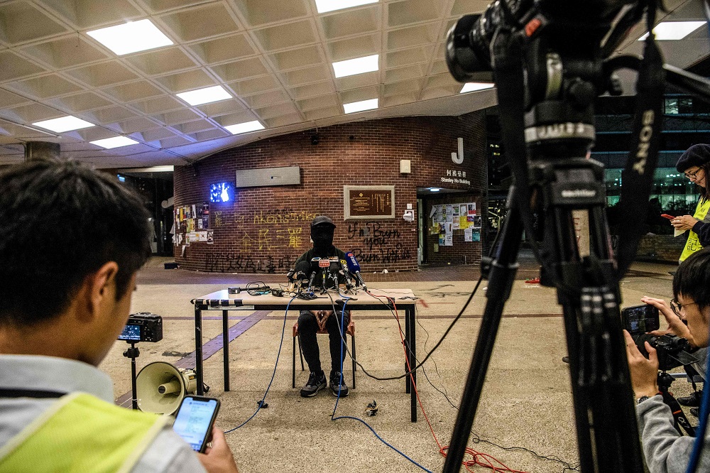 A protester speaks to the media at the Hong Kong Polytechnic University campus in the Hung Hom district of Hong Kong late on November 27, 2019, over a week after police surrounded the building while protesters were still barricaded inside. u00e2u20acu2022 AFP pic  