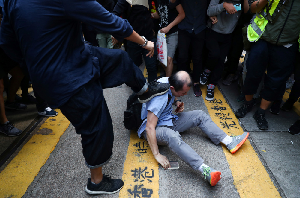A man gets beaten by anti-government demonstrators during a protest in Central, Hong Kong, China November 14, 2019. u00e2u20acu201d Reuters pic 