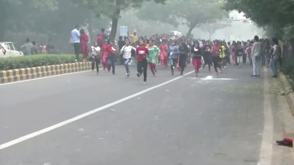 Children run a race in thick smog as schools are shut in New Delhi, India, November 14, 2019 in this still image taken from a video. u00e2u20acu201d ANI pic via Reuters 