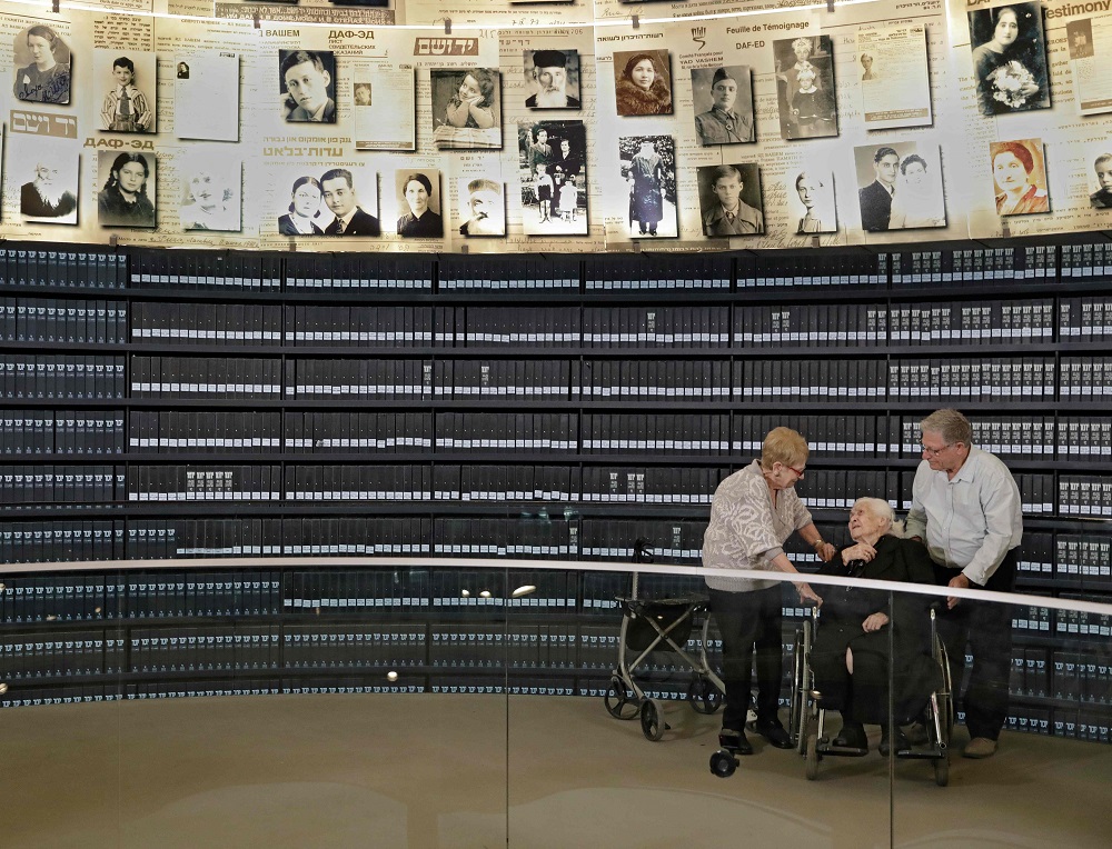 Greek World War II rescuer Melpomeni Dina (centre) talks with holocaust survivors Yossi Mor and his sister Sarah Yanai, whom she helped escape in 1943, at the Hall of Names at the Yad Vashem Holocaust Memorial museum in Jerusalem  November 3, 2019. u00e2u20acu201d AF