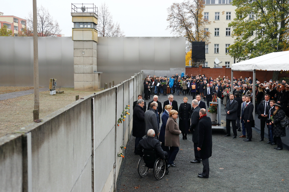 German Chancellor Angela Merkel, Parliament President Wolfgang Schaeuble and Berlin Wall Foundation Director Axel Klausmeier at the Wall memorial during a ceremony marking the 30th anniversary of the fall of the Berlin Wall at Bernauer Strasse in Berlin, 