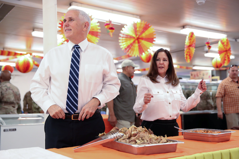 US Vice President Mike Pence and his wife Karen Pence help to serve a Thanksgiving meal to US troops in a dining facility at Camp Flores on Al Asad Air Base, Iraq November 23, 2019. u00e2u20acu201d Reuters picnnn