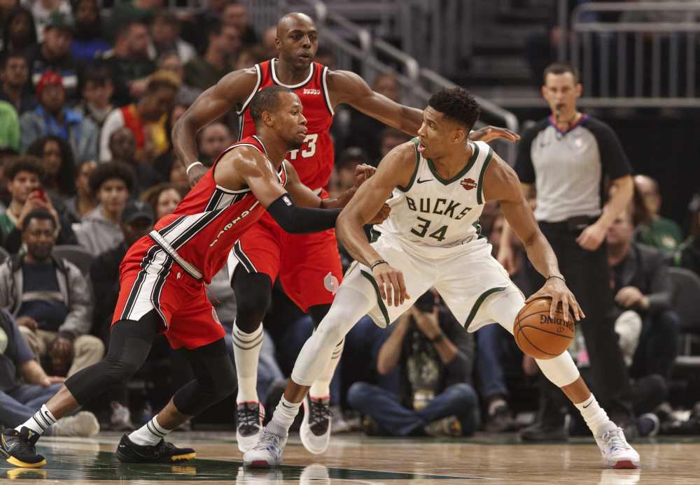 Milwaukee Bucks forward Giannis Antetokounmpo (34) dribbles the ball under pressure from Portland Trail Blazers guard Rodney Hood (5) and forward Anthony Tolliver (43) during the second quarter at Fiserv Forum. u00e2u20acu2022 Jeff Hanisch-USA TODAY Sports pic via Re