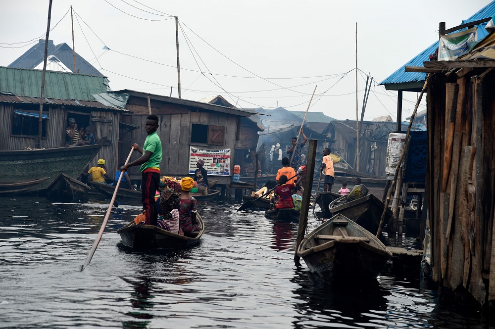 A boy stands on a canoe as part of his daily routine in the Makoko waterfront settlement in Lagos, Nigeria October 23, 2019. u00e2u20acu201d AFP pic  