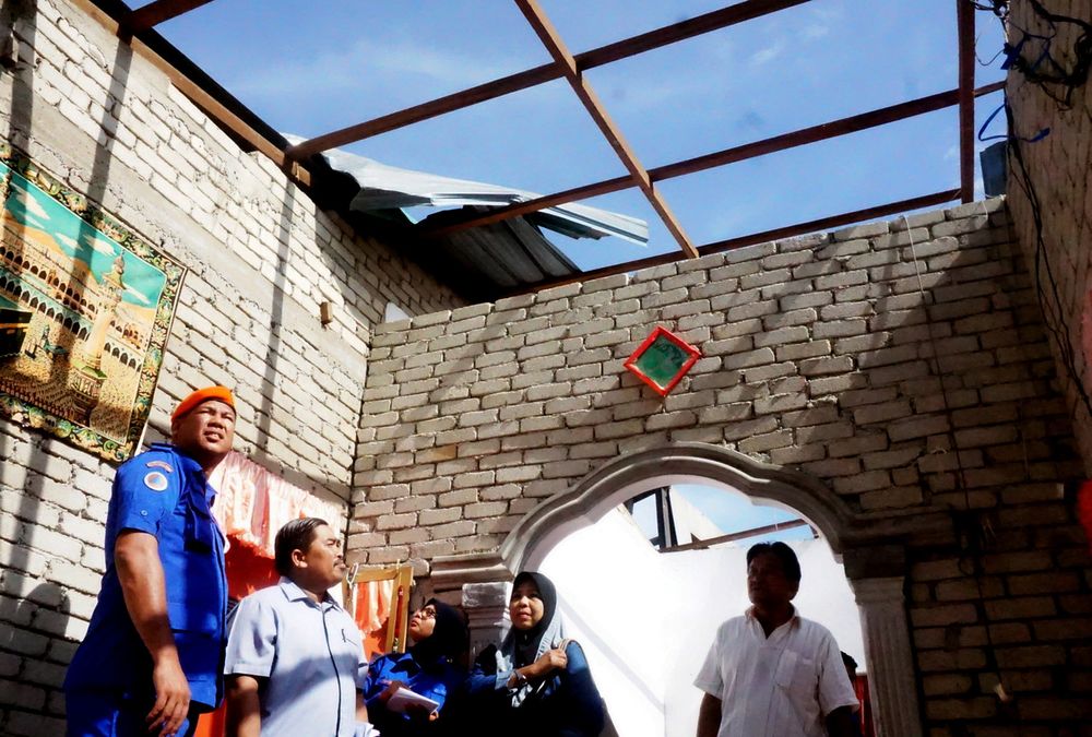 Kota Setar district civil defence officer Captain (PA) Md Zain Baharom (left) reviews the damage suffered by residents in a tornado incident in Kampung Padang, Mukim Tajar, November 17, 2019. u00e2u20acu201d Bernama pic