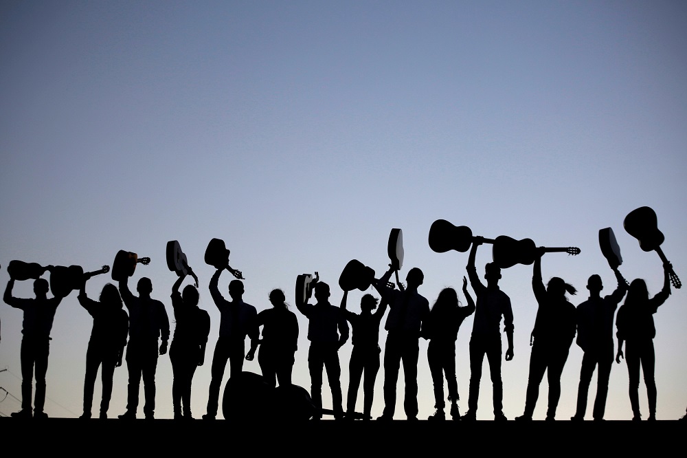 Members of a Rondalla, an ensemble of plectrum and stringed instruments, are silhouetted while holding up their instruments after performing in Ciudad Juarez, Mexico April 2, 2018. u00e2u20acu201d Reuters pic