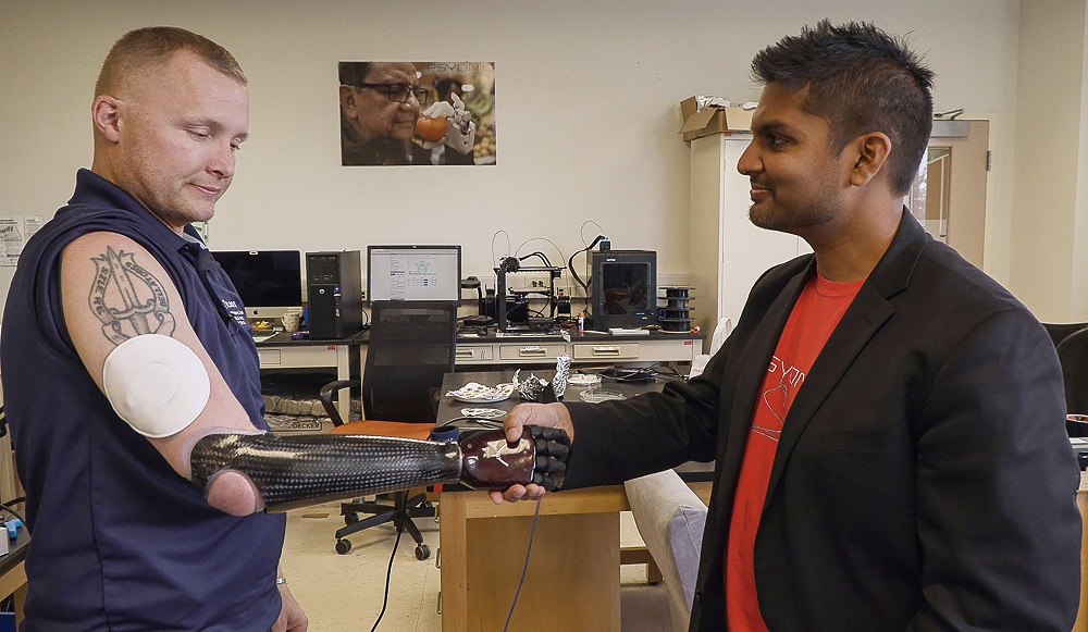 This photo released November 20, 2019, shows Garrett Anderson shaking hands with his prosthetic arm while wearing the wireless patch, a new second-skin VR technology which duplicates the sense of touch. u00e2u20acu201d Northwestern University/AFP pic