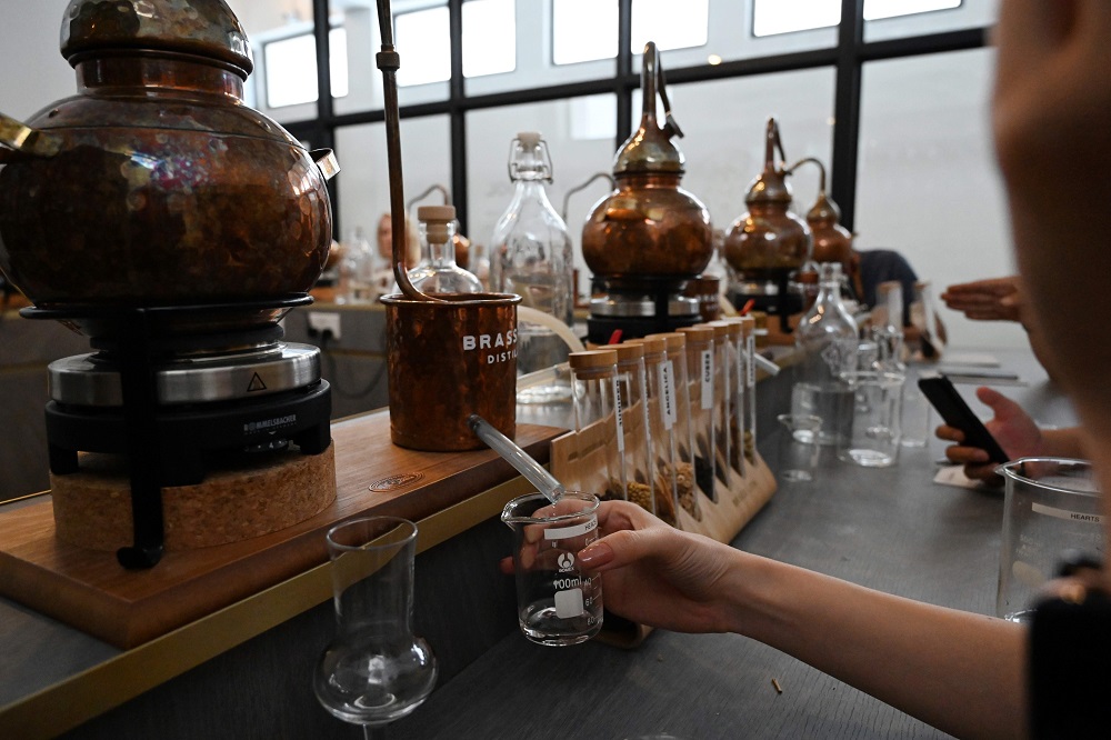 In this photo taken on October 13, 2019, a participant attends a gin making course at the Brass Lion Distillery school in Singapore. — AFP pic 