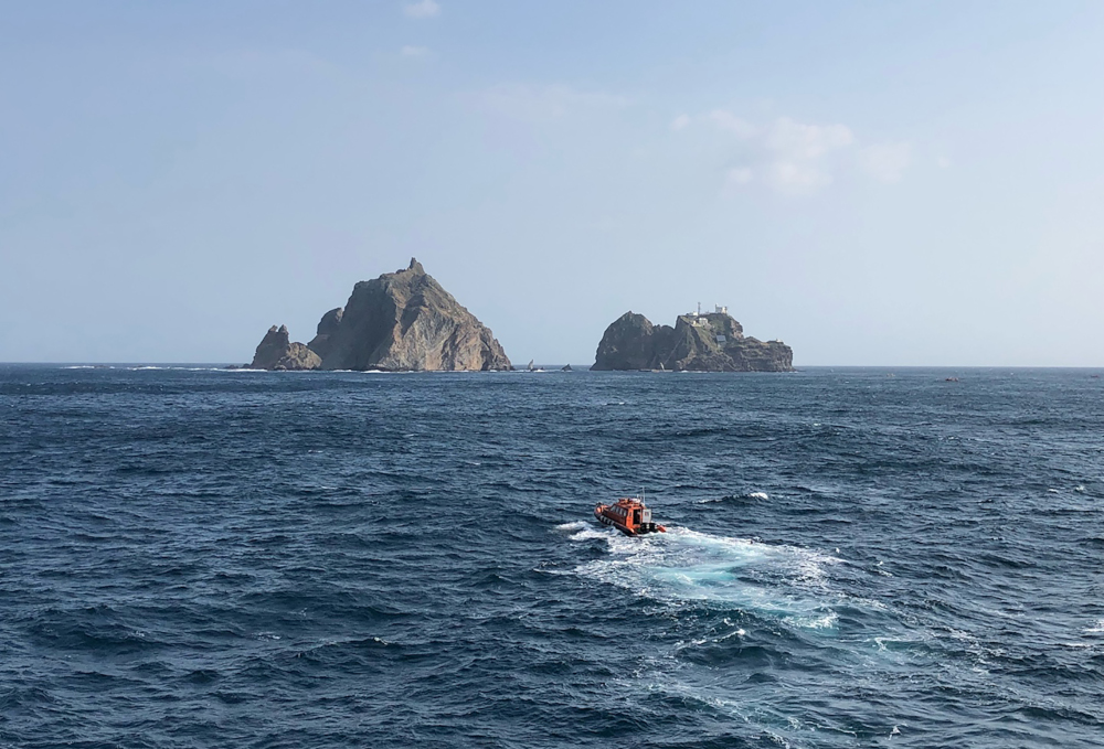 This handout photo taken November 1, 2019 and provided by the Korea Coast Guard shows rescue members searching for missing people after a helicopter crashed into the sea near the Dokdo islets, known as Takeshima in Japan. u00e2u20acu201d Korea Coast Guard handout pic