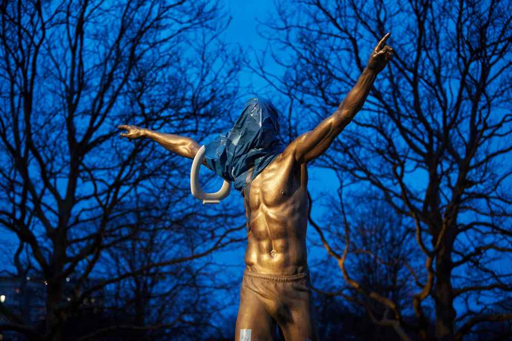 A statue of Zlatan Ibrahimovic is seen covered with a blue plastic bag and a toilet seat hanging on one arm in Malmoe, Sweden November 27, 2019. u00e2u20acu2022 Reuters pic
