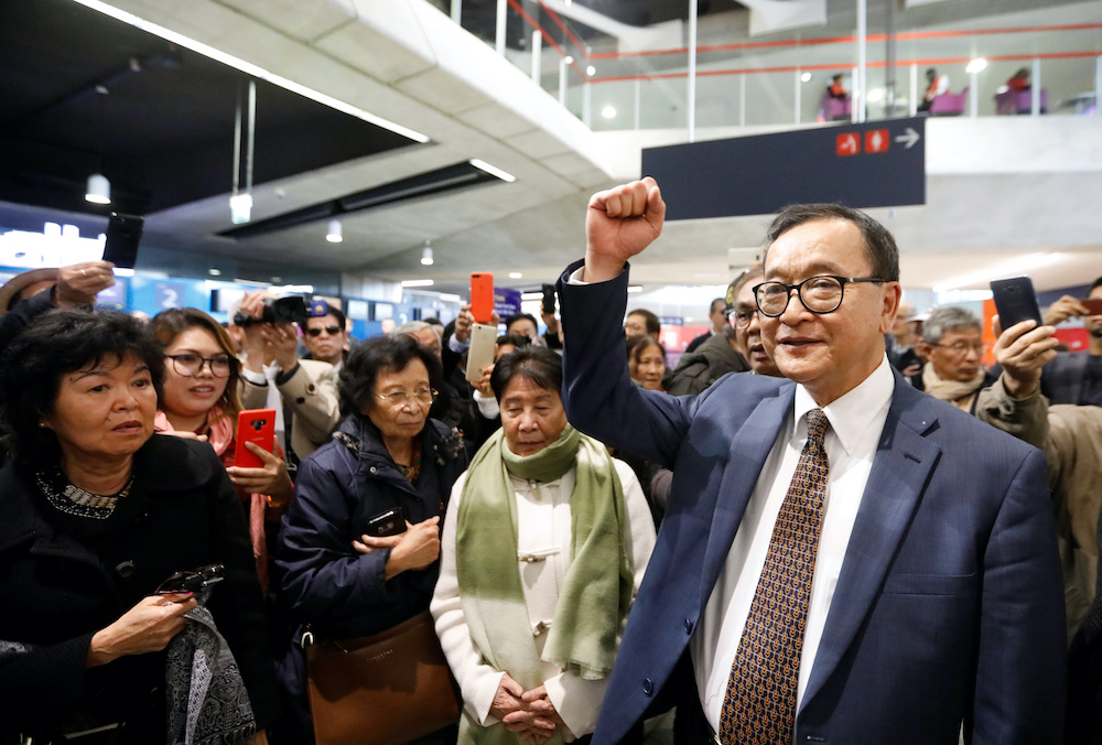 Cambodiau00e2u20acu2122s self-exiled opposition party founder Sam Rainsy, gestures to supporters after being prevented from checking-in for a flight from Paris to Bangkok at Roissy Airport in Paris, France November 7, 2019. u00e2u20acu201d Reuters pic