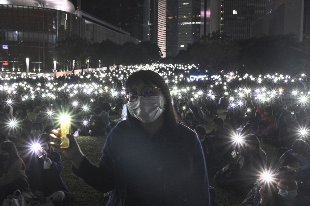 People light their mobile phones during a prayer rally in Hong Kongu00e2u20acu2122s Tamar Park on November 9, 2019, in memory of university student Alex Chow, 22, who succumbed to head injuries sustained during a fall. u00e2u20acu201d AFP pic
