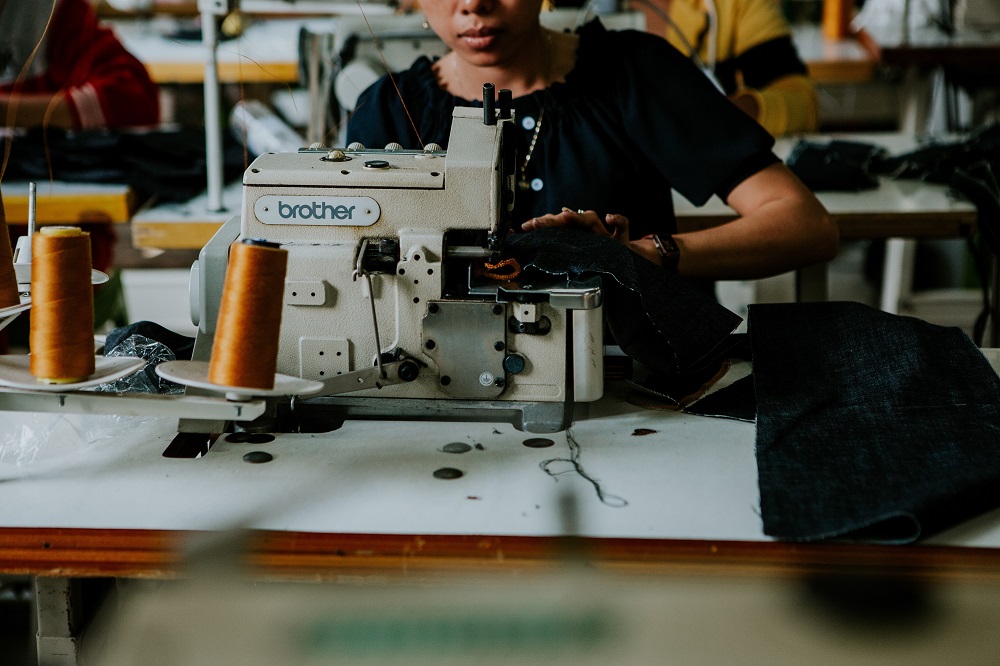 A seamstress works her sewing machine at the Outland Denim factory in Kampong Cham, in this undated handout photo. u00e2u20acu201d Amy Higg/Handout via Thomson Reuters Foundation pic