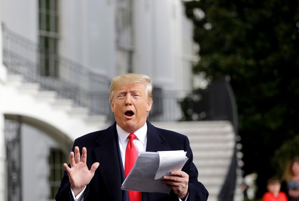 US President Donald Trump reads from his notes as he talks to the media on the South Lawn of the White House before boarding Marine One in Washington November 20, 2019, en route to Austin, Texas. u00e2u20acu201d AFP pic 