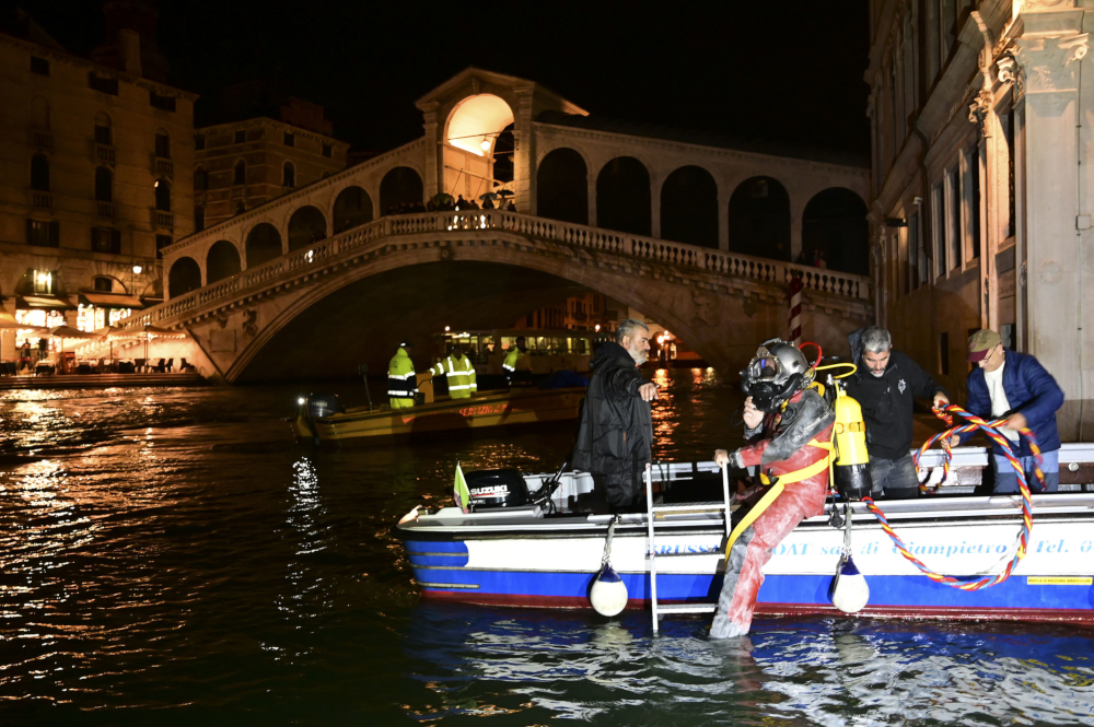 A scuba diver of the Venice Gondolieri association dives in the water of Canal Grande. u00e2u20acu201d AFP pic 
