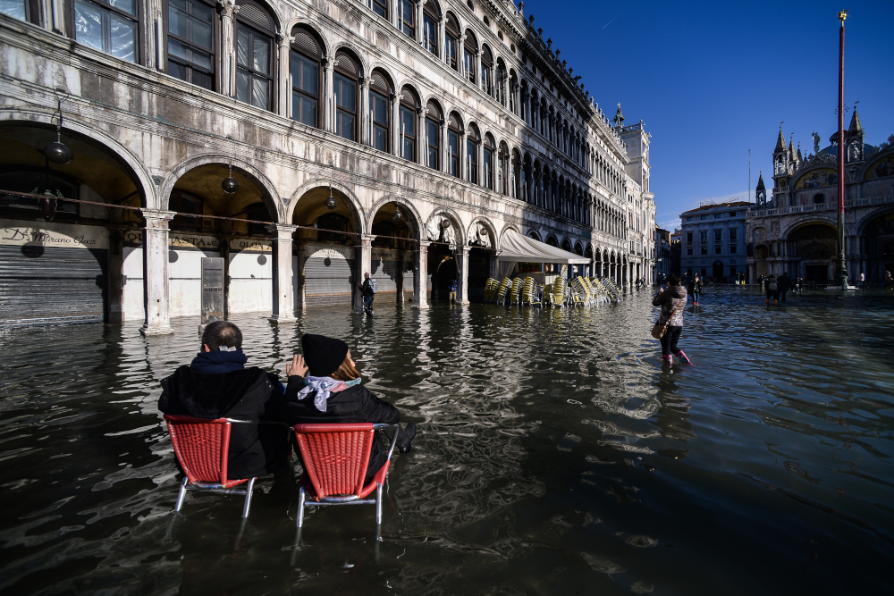 People sit on bistro chairs in the middle of the flooded St Marku00e2u20acu2122s Square November 14, 2019 in Venice. u00e2u20acu201d AFP pic 