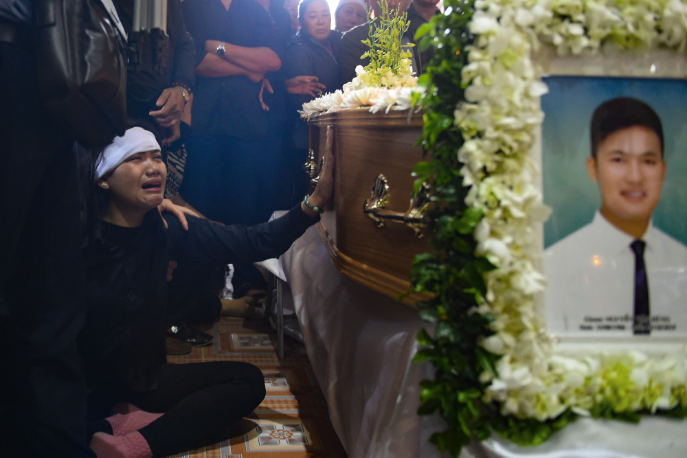 A family member cries before the coffin bearing the remains of Nguyen Van Hung during a funeral service at a church in Dien Chau district, Nghe An province November 28, 2019. u00e2u20acu201d AFP pic