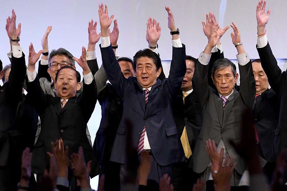 Japan's Prime Minister and ruling Liberal Democratic Party (LDP) leader Shinzo Abe (centre) leads 'Banzai' shouts at the end of his party convention in Tokyo March 25, 2018. u00e2u20acu201d AFP pic