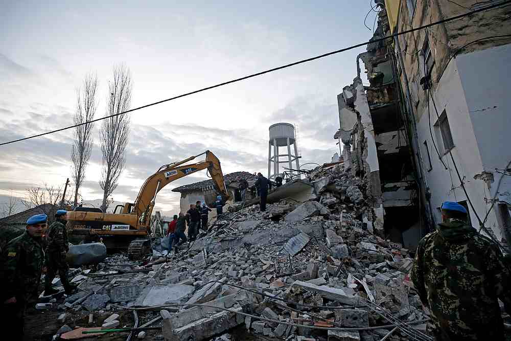 Emergency personnel work near a damaged building in Thumane, after an earthquake shook Albania November 26, 2019. u00e2u20acu201d Reuters pic