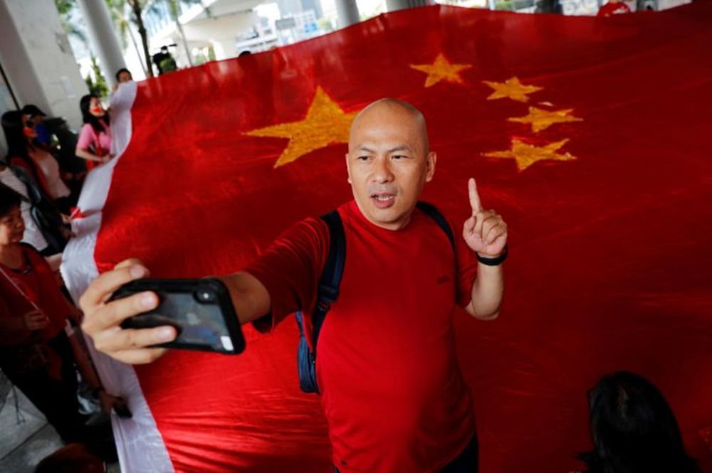 Pro-China supporter Alex Yeung, owner of Wah Kee Restaurant, reacts next to a giant Chinese national flag as he and others celebrate Chinau00e2u20acu2122s National Day in Hong Kong, China October 1, 2019. u00e2u20acu201d Reuters pic
