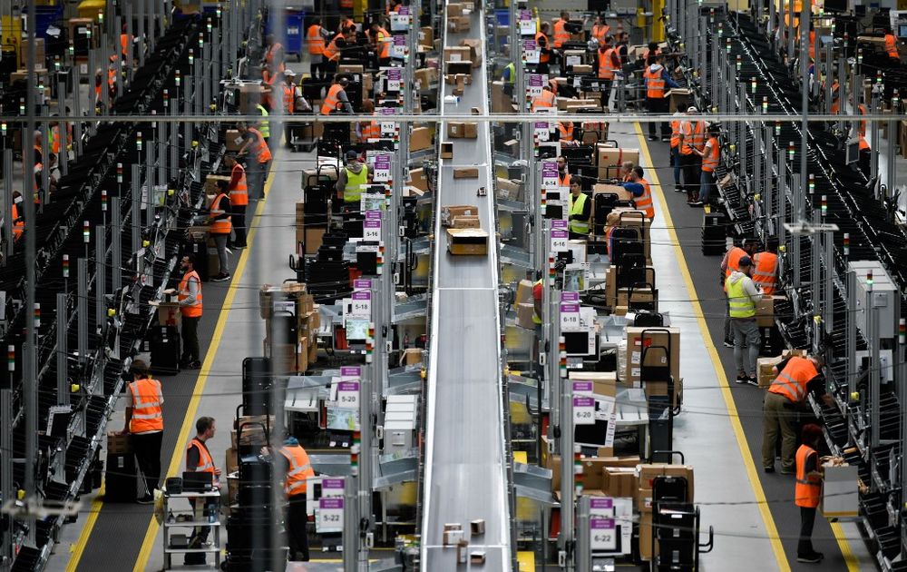 File photo taken on November 08, 2018 shows employees working at the distribution centre of US online retail giant Amazon in Dortmund, Germany. Hundreds of Amazon workers in Germany walked off the job as the US online retailer kicked off its u00e2u20acu02dcBlack Frid